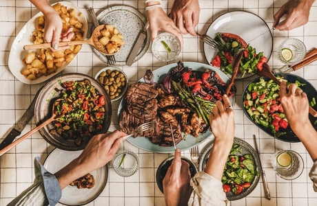 Flat lay of people having barbeque party with meat and vegetables