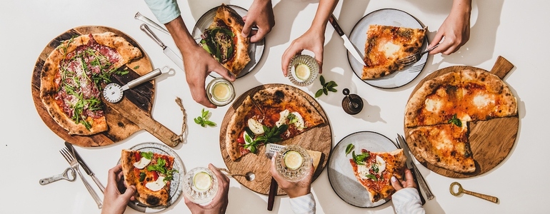 Flat lay of various pizzas  drinks and people celebrating