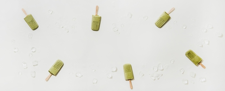 Flat lay of green matcha coconut popsicles  copy space