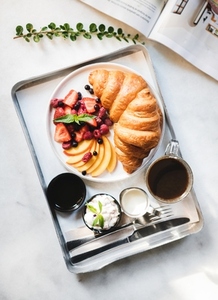 French breakfast with croissant  berries  jam and black coffee