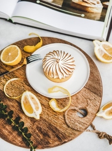 Lemon tart with merengue sweet dessert over white marble table