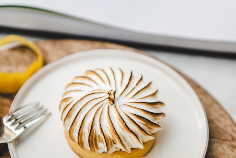 Lemon tart with merengue sweet french dessert in cafe