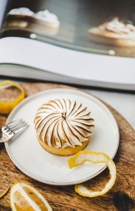 Lemon tart with merengue sweet french dessert in cafe