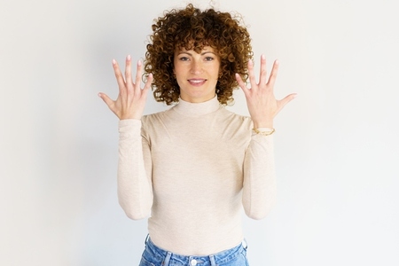 Smiling woman showing hands in studio