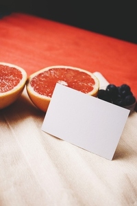 Mockup of a business card in vibrant tones near to fresh fruit g