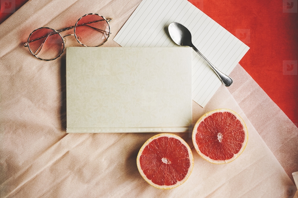 Flat lay background image with a elegant diary surrounded by com