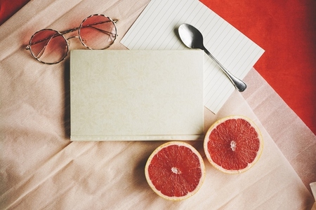 Flat lay background image with a elegant diary surrounded by com