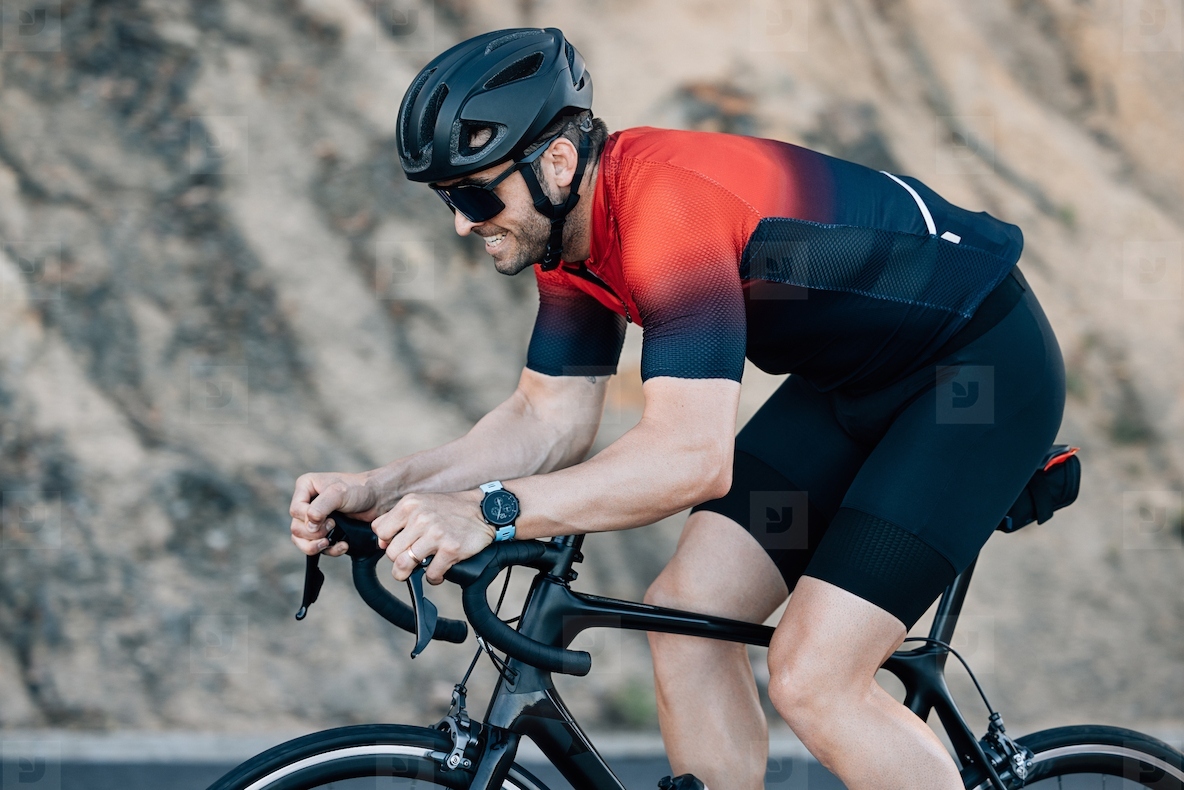 Cyclist doing intense ride outdoors  Professional male road bike rider training outdoors