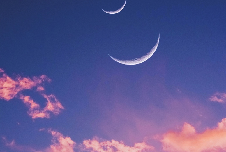 surreal and dreamy background of a pastel colors sky with moon