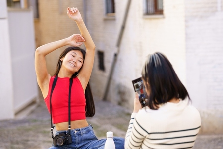 Asian woman posing for photo on street