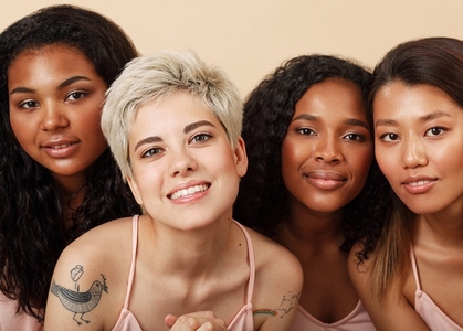 Group portrait of four diverse women in the studio  Female with different skin colors sitting together
