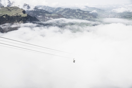 Ski gondola above clouds