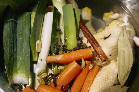 Fresh vegetables and cinnamon stick cooking in pot