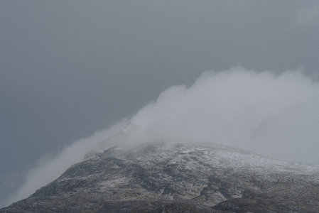 Clouds over snowcapped mountain Assynt