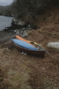 Kayaks and boat on shore