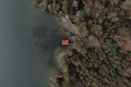 Aerial view roof of fishing hut at lake waterfront