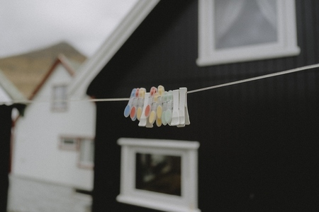 Clothespins on clothesline outside houses in fishing village