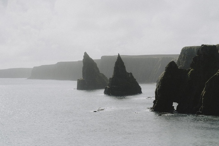 Dramatic rock formations and cliffs over ocean