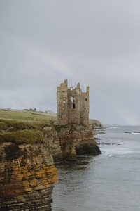 Castle ruins at edge of cliff above ocean