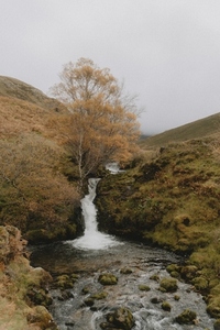 Idyllic waterfall in remote autumn landscape