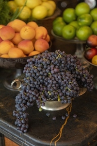 Still life fresh grapes nectarines and citrus fruits in bowls