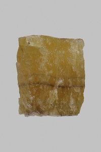 Close up textured yellow Chinese fluorite stone on gray background