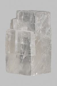 Close up translucent Icelandic calcite stone on gray background
