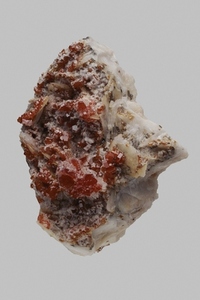 Close up detail textured red Moroccan vanadinite stone on gray background