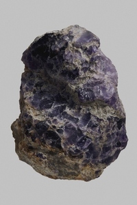Close up detail textured purple Spanish fluorite stone on gray background