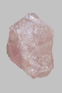 Close up pink Madagascan rose quartz stone on gray background