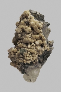 Close up detail textured brown German fluorite quartz and chalcopyrite on gray background