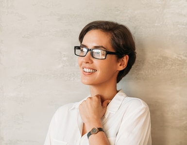 Confident businesswoman in eyeglasses in formal white clothes