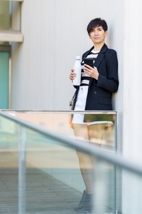 Adult woman using mobile phone while looking away