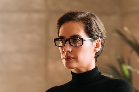 Portrait of a confident Caucasian businesswoman in eyeglasses looking away