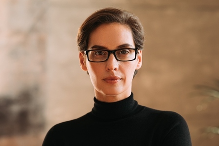 Portrait of an adult businesswoman in eyeglasses   Confident woman working in CEO position in a company looking at camera