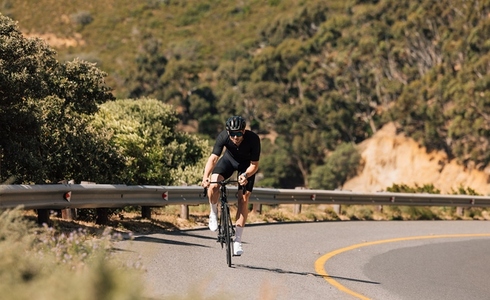 Fit cyclist doing an intense ride on an empty mountain road