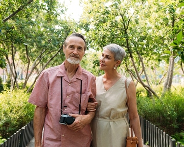Aged woman and her husband walking in the park