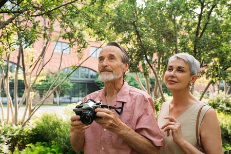 Two senior tourists exploring the park during vacation