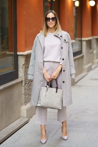 Confident stylish female standing on sidewalk