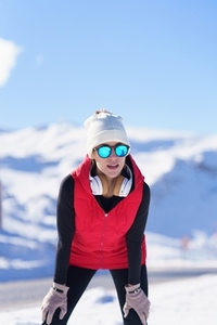 Female runner in warm clothes in winter