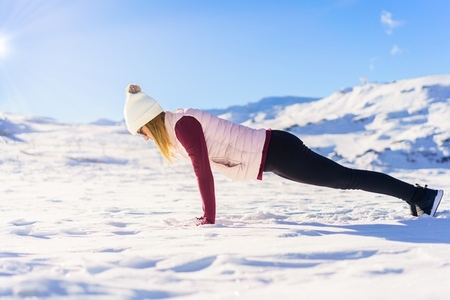 Woman doing yoga in high plank pose