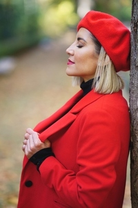 Stylish woman near tree in autumn park
