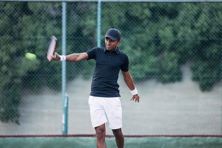 Professional tennis player hitting a ball during a match