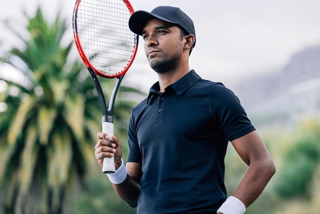 Portrait of a young tennis player with a racket