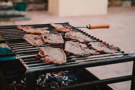 Fresh meat steaks on a grill  su