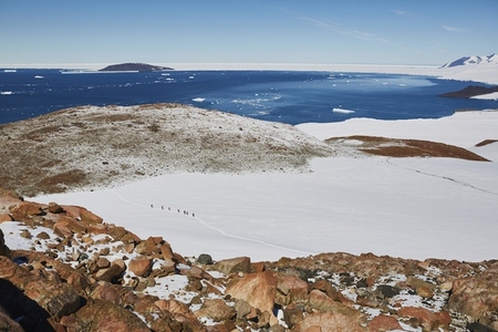 Tourists crossing sunny snowy glacier Antarctic Peninsula Weddell Sea Antarctica