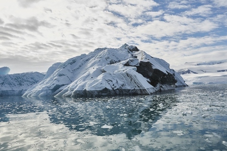 Melting iceberg on sunny blue ocean surface off Antarctic Peninsula Weddell Sea Antarctica