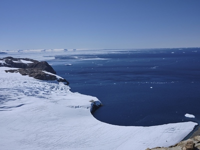 Snowy glacier against sunny blue ocean Antarctic Peninsula Weddell Sea Antarctica