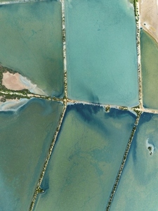 Aerial view of vibrant turquoise salt ponds Majorca Spain