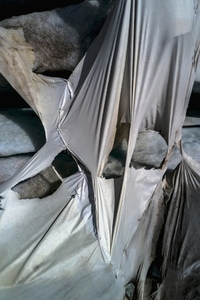 Aerial view ripped protective tarpaulin over Rhone Glacier Switzerland